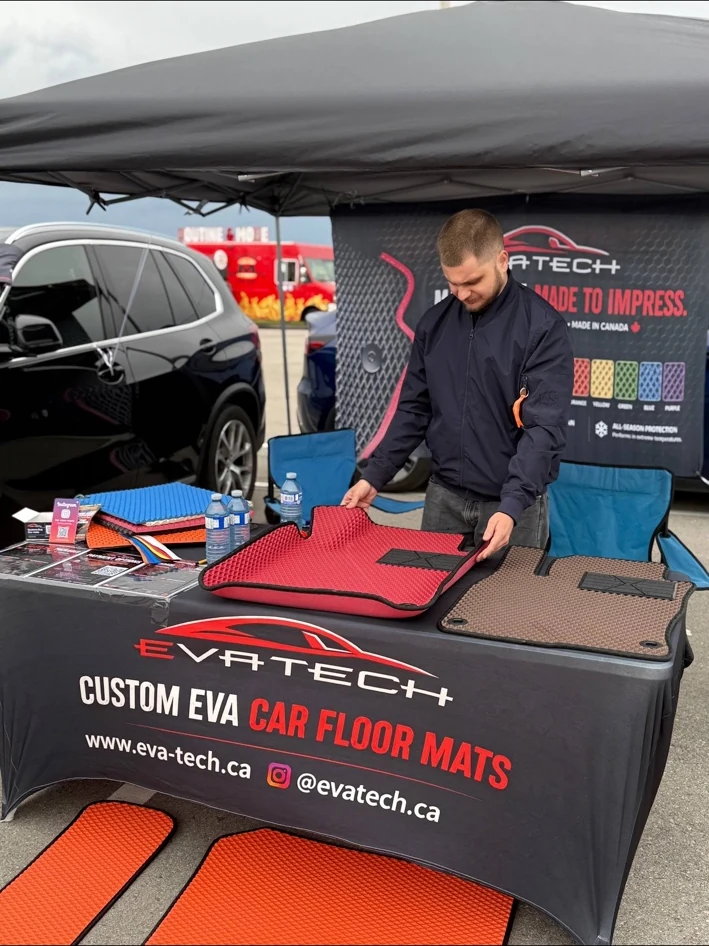EVATECH team member presenting custom EVA mats at a local automotive event